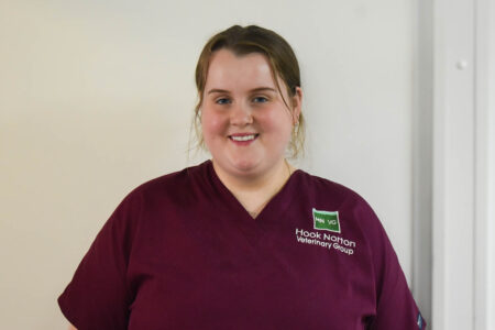 Molly McCluskey, Hook Norton Veterinary Group team member, smiling in a maroon scrub top